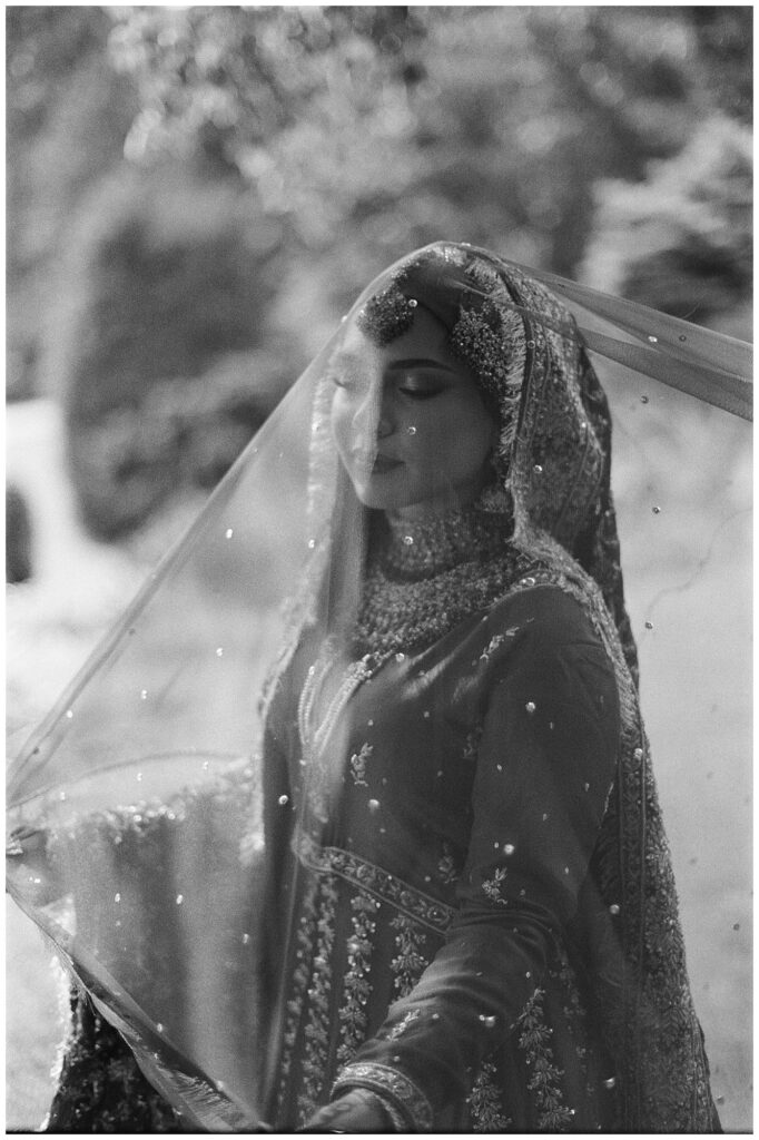 Pakistani bride posing for bridal portraits on film at Gairloch Gardens in Oakville, Ontario.