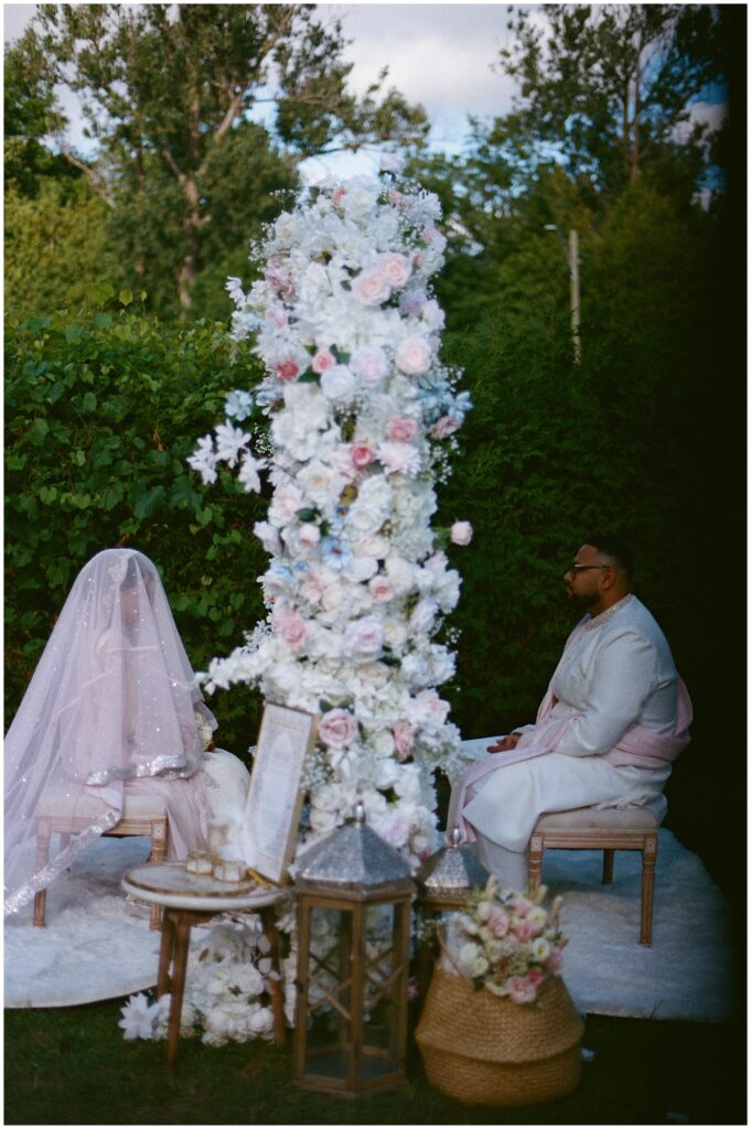 A Pakistani Muslim couple during their outdoor nikkah ceremony at the Bella Gardens in King City, captured on film with soft light and timeless, emotional wedding photography.