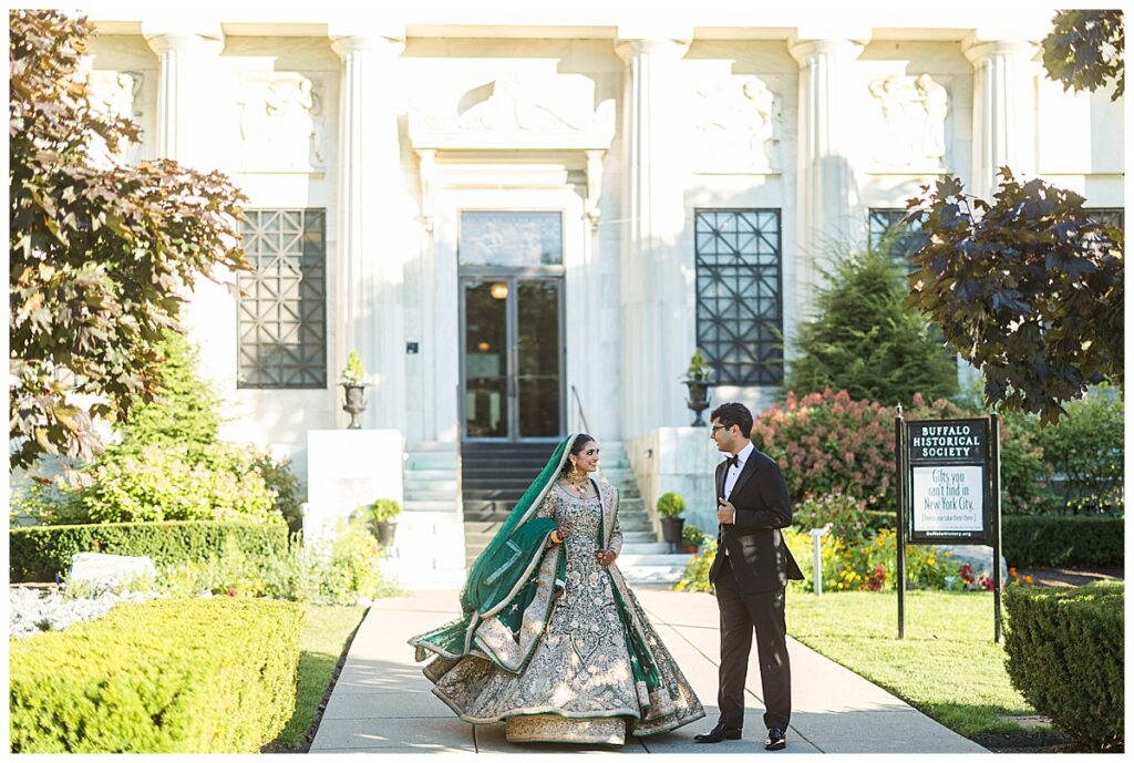 Pakistani bride and groom posing for Valima portraits at AKG Museum in Buffalo NY Buffalo History Museum