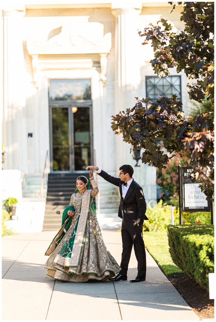 Pakistani bride and groom posing for Valima portraits at AKG Museum in Buffalo NY Buffalo History Museum